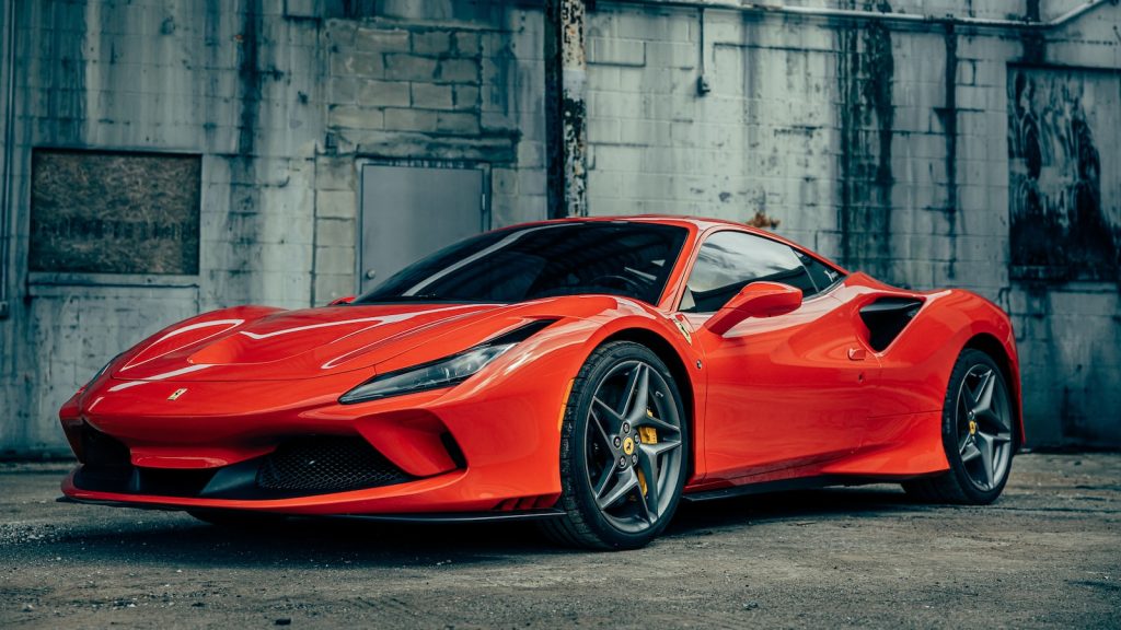 red ferrari 458 italia parked near gray building